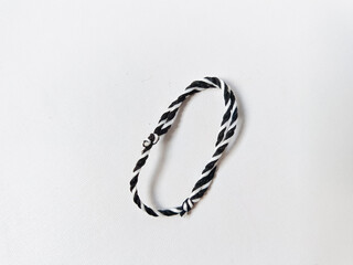 The tridatu bracelet is a traditional Balinese bracelet made of three threads with red, white, and...