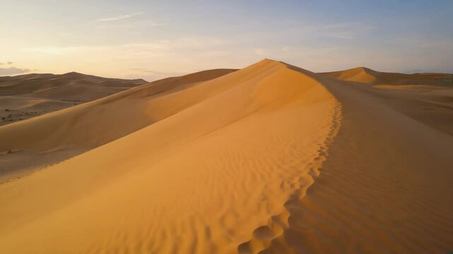 soft sand dunes stretching across the dry desert with smooth shapes and golden colors under natural daylight, peaceful and scenic view