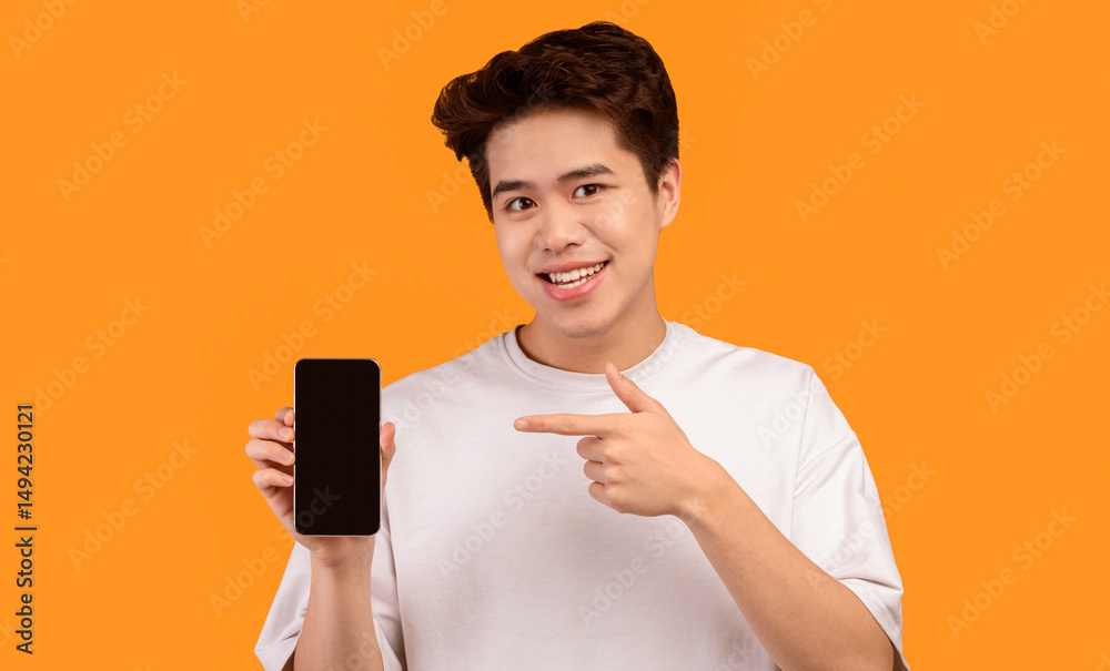 Fototapete i recommend this website. smiling young asian man holding smartphone with black empty screen in hand