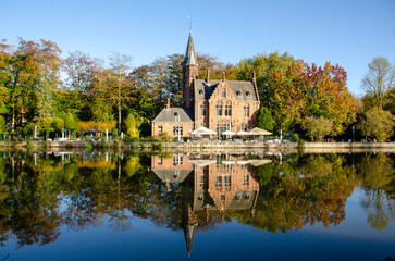 Naklejka premium The Lake of Love in Bruges is an enchanting setting, perfect for romantics. With its graceful swans and serene landscape, the lake inspires passion and tranquility. Bruges, Belgium.