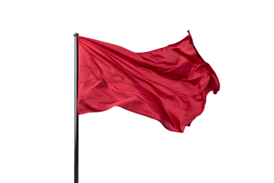 A red flag waves on a pole, capturing motion and vivid color.
