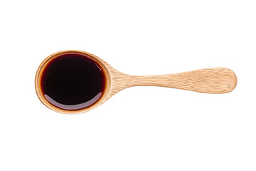 A wooden spoon filled with dark liquid.