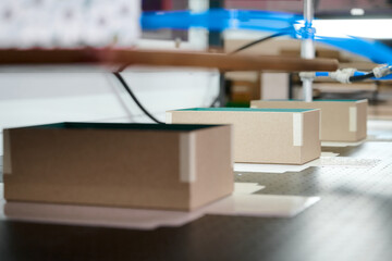 Production of decorative cardboard boxes on a conveyor belt in a modern packaging factory showcasing the manufacturing process and efficiency