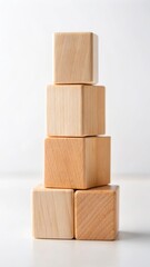 Obraz premium Wooden toy blocks stacked neatly on a white light background with soft focus effect