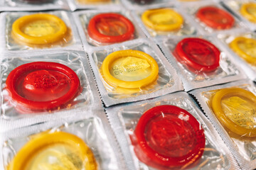 Colorful condom on background. large number of condoms. concept of safe sex. lots of rubber condoms. bunch of objects