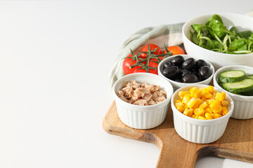 Cooking salad with tuna on a light background.