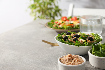 Salad with tuna on a gray table.