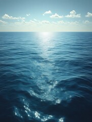 Obraz premium Calm ocean surface with sunlight reflection.