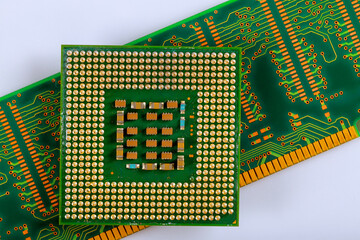 Detailed microprocessor sits atop green circuit board featuring numerous soldered connections...