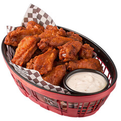 A big basket filled with hot and saucy buffalo chicken wings sits on the table accompanied by a side of creamy dipping sauce perfect for enjoying with friends