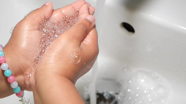 Hand washing demonstration for kids with soap bubbles