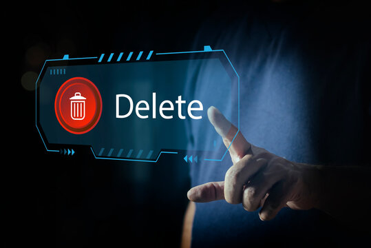 Man pushing the delete button on virtual screen. The concept of deletion or erase contacts, Deleting files from the system. Spam mail, electronic messages or personal data in computer systems. - Powered by Adobe