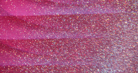 Flaring lens red. Blur glitter texture. Abstract colorful glow pink golden particles on bokeh light crimson background.
