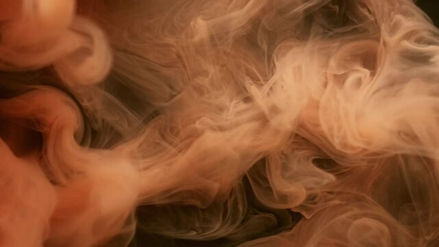 Smoke twist. Paint burst. Orange puff spray shot spread on black background. Abstract water color blob explosion blur haze fantasy mist.