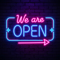 Obraz premium A vibrant neon sign on a dark purple brick wall background. The sign features the words 