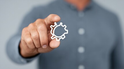 A hand interacts with a digital gear icon.