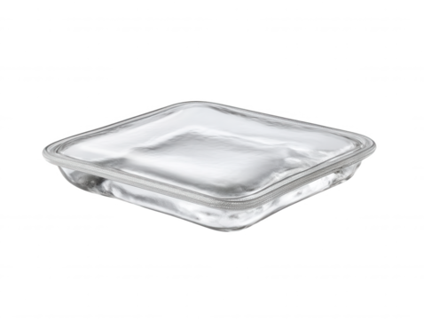 Square glass container with rounded corners and subtle texture rests on a white surface, illuminated to highlight its clarity and simple, elegant design.