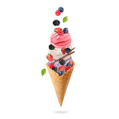 Yummy ice cream balls in wafer cone and berries in air on white background