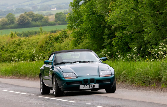 Upper Winchendon,Bucks,UK - May 18th 2025:   1991 green BMW Z1 classic car driving in the British countryside.