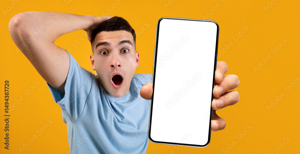 Poster wow, super huge discount. portrait of shocked guy grabbing head holding smartphone with white empty 