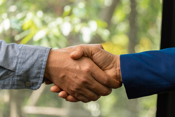 Businessmen join hands with business building construction engineers to trust business partners and relationships to achieve future trade and investment goals.	
