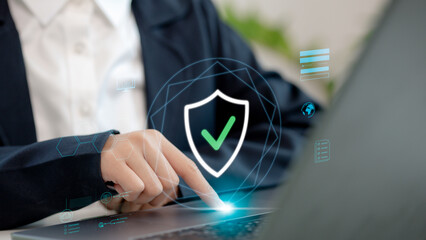 Businesswoman touching a virtual security shield with checkmark icon, symbolizing cybersecurity,...