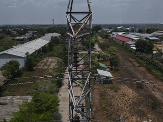 Electricity generated from generation is distributed through transmission towers before reaching consumers. Transmission towers pass on the roof of densely populated residential house in a city