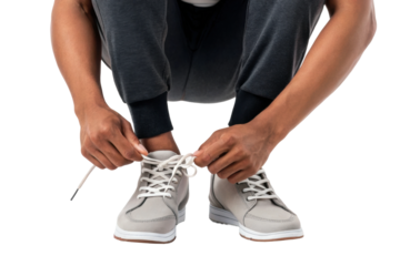 PNG Male tying sneakers wearing casual grey pants on black background