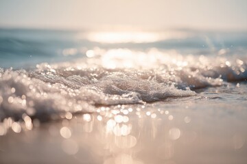 Sunlit Ocean Waves with Sparkling Highlights Blurred Sandy Beach
