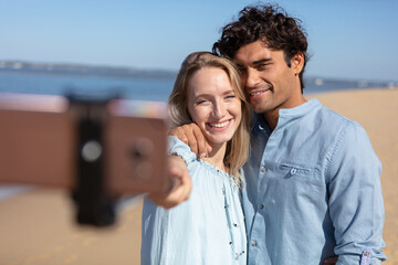 beautiful couple in love doing self on a tropical beach