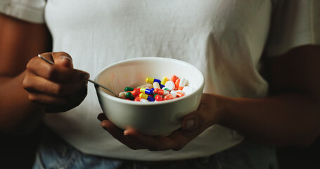 Hands, bowl and pills for addiction in studio with eating for mind altering drugs by black...