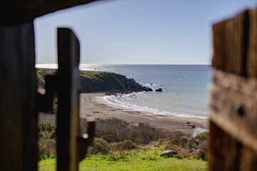 View of ocean cove through old wooden shutters 