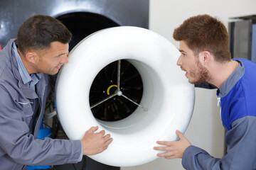 engineer showing turbine to young apprentice