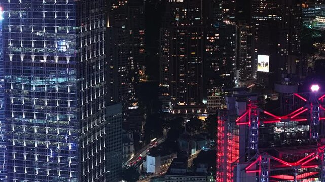 Glowing City Lights Illuminating Skyscrapers, Revealing Vibrant Financial District. Futuristic Skyline At Night. Financial District in Downtown. Modern Architectural Design And Urban Development