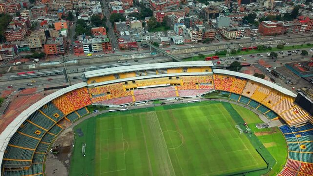 Aerial orbit establishing the El Campin stadium, with completely empty stands on a sunny day in Bogota, Colombia.