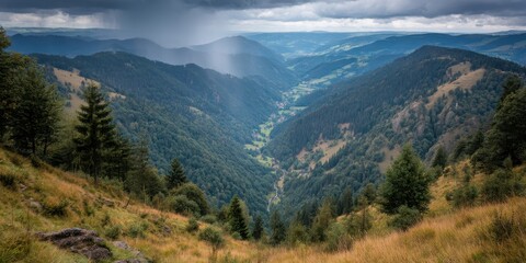 Obraz premium Earth Day Concept. A serene mountain valley with dramatic clouds looming overhead, showcasing lush greenery and distant hills.