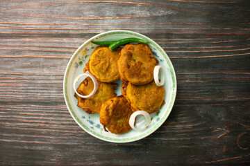 Alu Chop served in plate isolated on wooden background top view of bangladeshi food