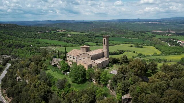 Beautiful hilltop church with beautiful landscape in the background in Catalonia, Spain. High quality 4k aerial drone footage