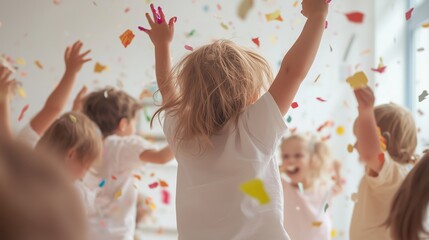 Children celebrate joyfully with confetti in a bright indoor play area during a festive event
