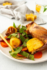 Enjoy a delicious, hearty meal with baked rabbit, roasted potatoes, and carrot salad, combining savory flavors and wholesome ingredients for a nutritious and satisfying dinner