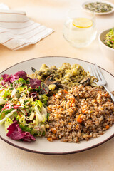 Delicious healthy breakfasts, buckwheat porridge with mixed salad with seeds and fried mushrooms with eggs, top view of plates with food