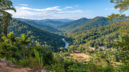 Lush tropical valley with dense forest, winding river, and distant mountain views
