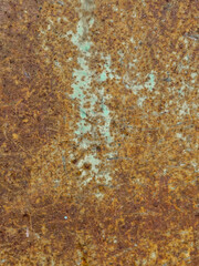 Closeup of a heavily rusted metal surface showing detailed corrosion and texture.