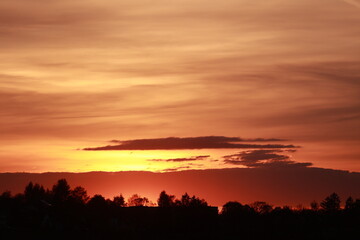 The sky is orange and the sun is setting