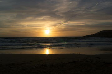 Fototapeta premium Stunning sunset over sea in Golden Bay Malta.