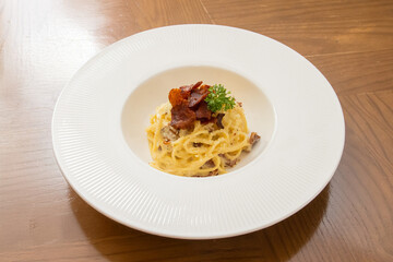 Capellini Carbonara Sauce on wood table