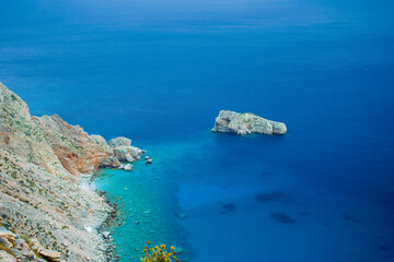 Turquoise Waters and Rocky Cliffs of a Remote Island in the Aegean Sea, Greece – Aerial Coastal Landscape with Crystal-Clear Blue and Green Sea