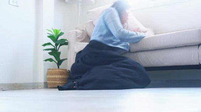 Woman suddenly faints and falls down while walking in the room, possibly from low blood pressure, heart problem, or passing out episode
