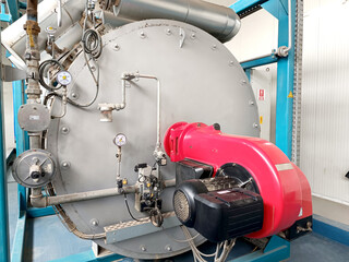 Obraz premium Interior of an industrial boiler room with boilers, many pipes, valves and sensors
