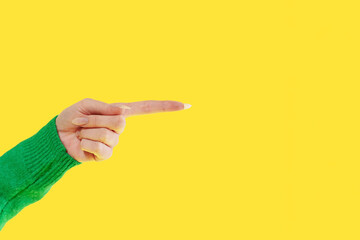 Hand pointing with bright yellow background, showcasing clear communication in a vibrant and...